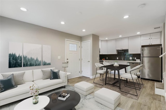935 La Posada Dr Unit 158, Austin, TX 78752 - living area with light wood-style floors, recessed lighting, and baseboards