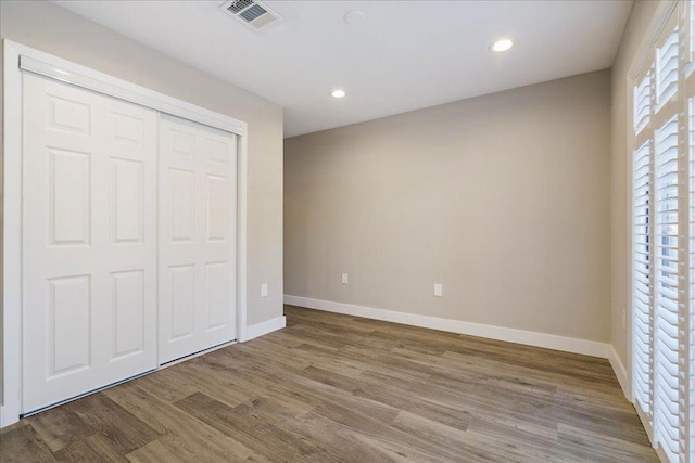 935 La Posada Dr Unit 158, Austin, TX 78752 - unfurnished bedroom with wood finished floors, recessed lighting, and a closet