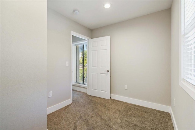 935 La Posada Dr Unit 158, Austin, TX 78752 - carpeted empty room featuring plenty of natural light, baseboards, a smoke detector, and recessed lighting