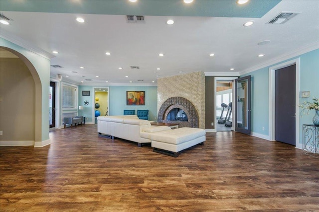 935 La Posada Dr Unit 158, Austin, TX 78752 - living room with ornamental molding, baseboards, wood finished floors, recessed lighting, and arched walkways