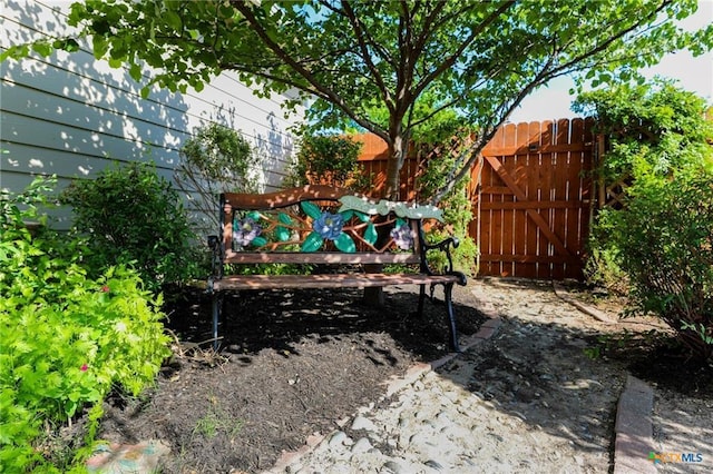view of yard featuring fence and a gate