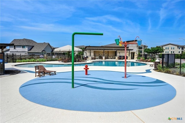 view of home's community featuring fence, a swimming pool, a patio, and a residential view