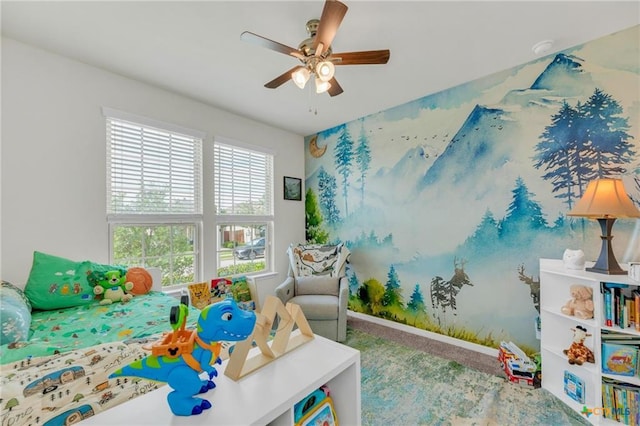 game room with a ceiling fan and carpet flooring