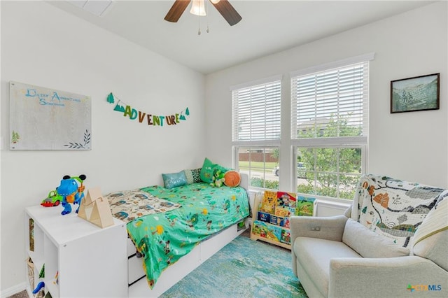 bedroom featuring multiple windows and ceiling fan