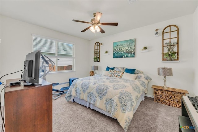 carpeted bedroom featuring a ceiling fan and baseboards