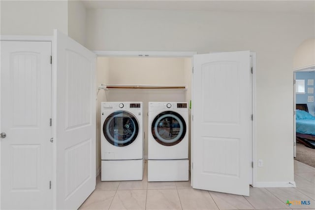 512 Canadian Springs Dr, Leander, TX 78641 - laundry room with washer and dryer and light tile patterned flooring