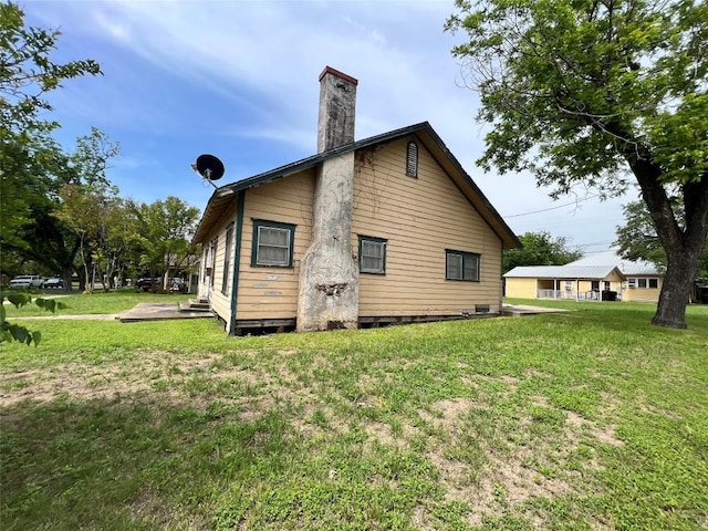 1118 N 2nd St, Temple, TX 76501 - back of house featuring a lawn and a chimney