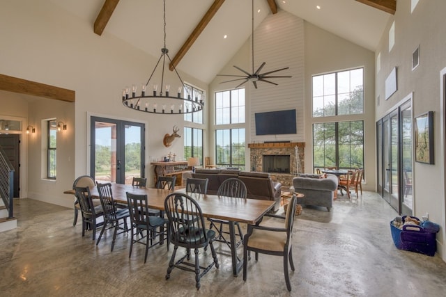 1433 Althaus Ranch Rd, Johnson City, TX 78636 - dining room featuring french doors, high vaulted ceiling, beamed ceiling, a fireplace, and finished concrete floors