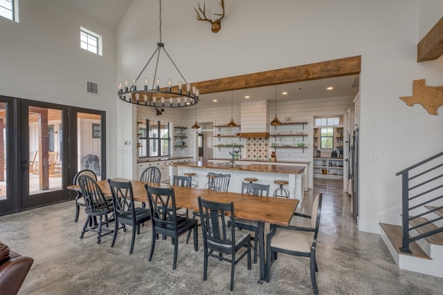 1433 Althaus Ranch Rd, Johnson City, TX 78636 - dining room with a towering ceiling, french doors, stairs, baseboards, and a chandelier