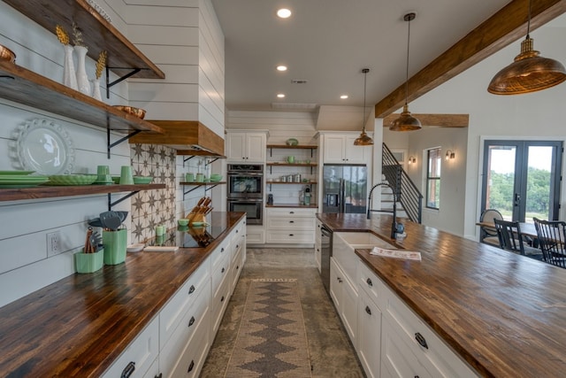1433 Althaus Ranch Rd, Johnson City, TX 78636 - kitchen featuring open shelves, butcher block counters, double oven, refrigerator with ice dispenser, and a sink