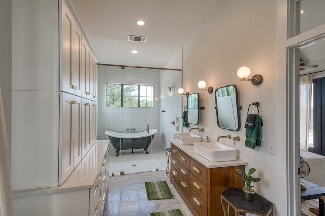 1433 Althaus Ranch Rd, Johnson City, TX 78636 - full bath with a freestanding bath, double vanity, tile walls, and recessed lighting