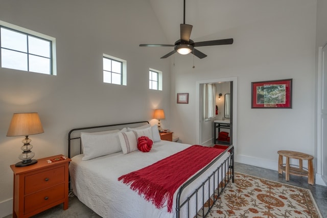 1433 Althaus Ranch Rd, Johnson City, TX 78636 - bedroom featuring a towering ceiling, ensuite bath, baseboards, and ceiling fan