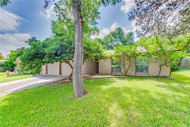 7309 Whispering Oaks Dr, Austin, TX 78745 - obstructed view of property featuring driveway, a front lawn, and brick siding