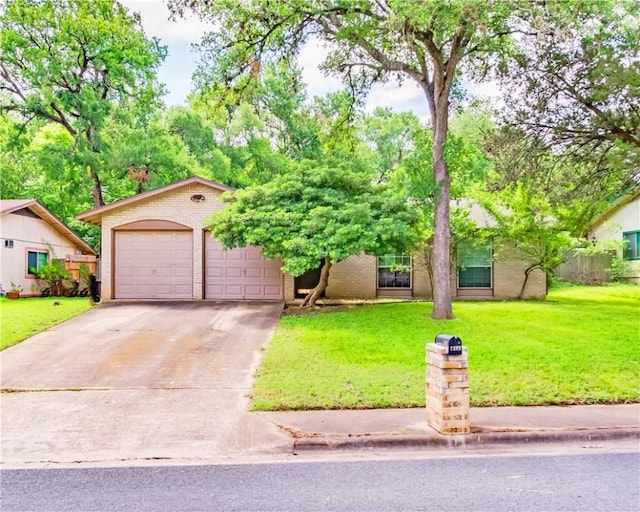 7309 Whispering Oaks Dr, Austin, TX 78745 - view of front of property with brick siding, a front yard, and a detached garage