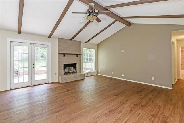 7309 Whispering Oaks Dr, Austin, TX 78745 - unfurnished living room with a ceiling fan, light wood-type flooring, french doors, and a brick fireplace