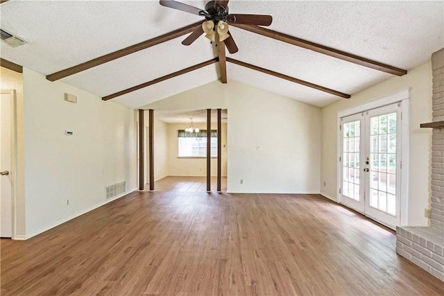 7309 Whispering Oaks Dr, Austin, TX 78745 - unfurnished room with a chandelier, light wood-style floors, a ceiling fan, french doors, and a textured ceiling