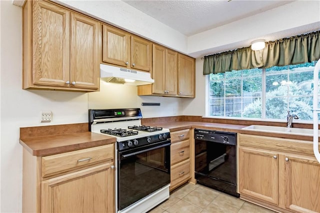 7309 Whispering Oaks Dr, Austin, TX 78745 - kitchen with dishwasher, under cabinet range hood, gas stove, light tile patterned floors, and light brown cabinetry