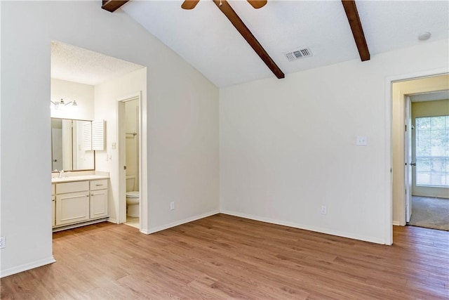 7309 Whispering Oaks Dr, Austin, TX 78745 - unfurnished bedroom with light wood-style flooring, ensuite bathroom, and a ceiling fan