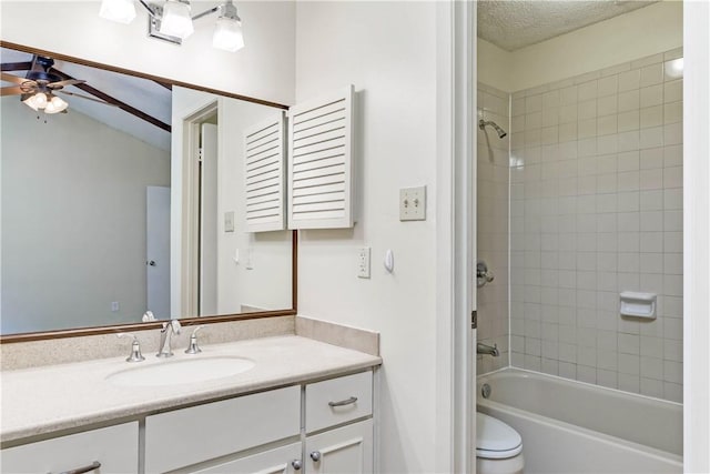 7309 Whispering Oaks Dr, Austin, TX 78745 - bathroom with ceiling fan, toilet, tub / shower combination, vanity, and a textured ceiling