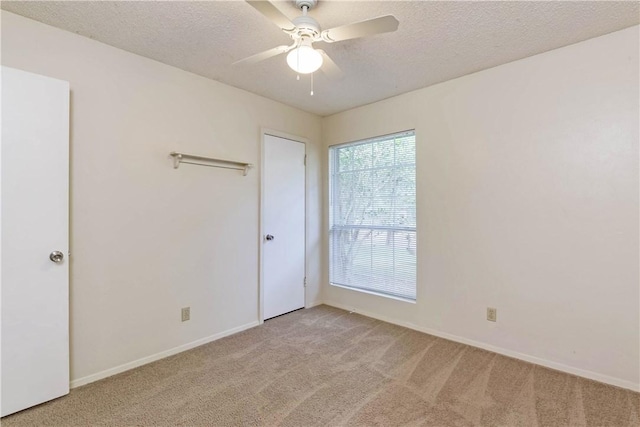 7309 Whispering Oaks Dr, Austin, TX 78745 - unfurnished bedroom with light carpet, a textured ceiling, and ceiling fan