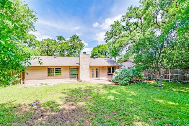 7309 Whispering Oaks Dr, Austin, TX 78745 - rear view of property with french doors, a chimney, and a patio