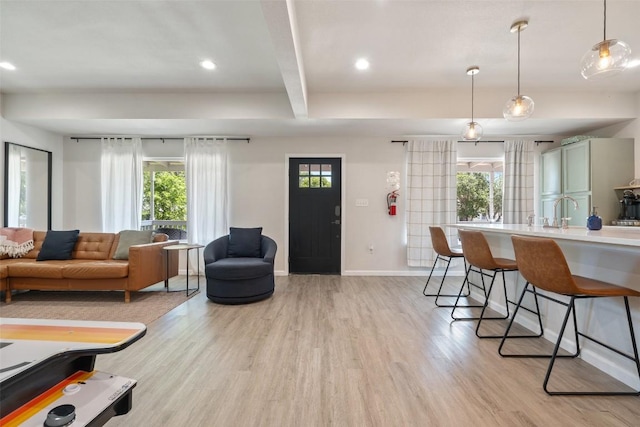306 Juarez St, San Marcos, TX 78666 - living area featuring light wood finished floors, beam ceiling, recessed lighting, and baseboards