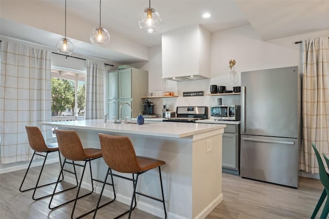 306 Juarez St, San Marcos, TX 78666 - kitchen with appliances with stainless steel finishes, custom exhaust hood, a sink, open shelves, and light wood-type flooring