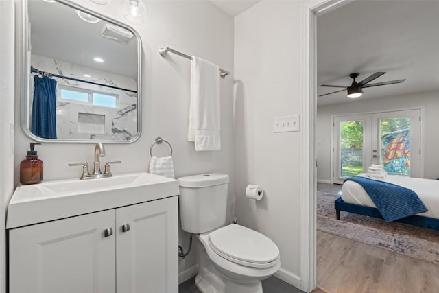 306 Juarez St, San Marcos, TX 78666 - ensuite bathroom featuring a ceiling fan, wood finished floors, toilet, baseboards, and french doors