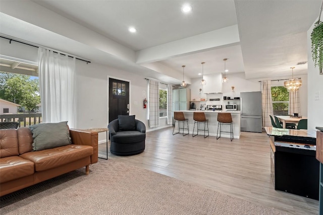 306 Juarez St, San Marcos, TX 78666 - living room with a chandelier, light wood finished floors, plenty of natural light, recessed lighting, and baseboards