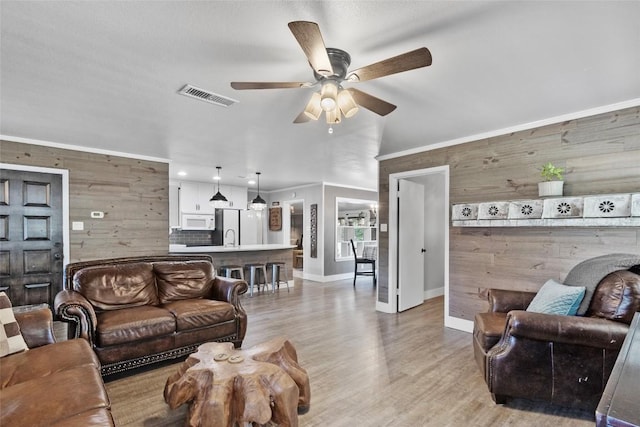 106 Apache Trl, Kingsland, TX 78639 - living area featuring wooden walls, a ceiling fan, baseboards, light wood finished floors, and recessed lighting