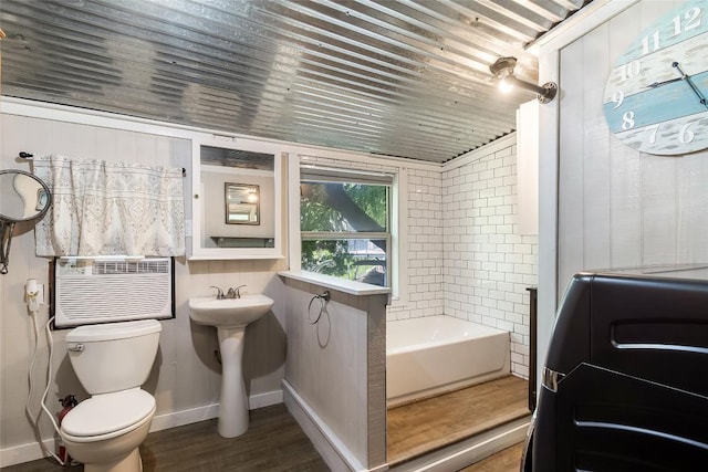 106 Apache Trl, Kingsland, TX 78639 - full bath with toilet, baseboards, wood finished floors, a tub to relax in, and cooling unit