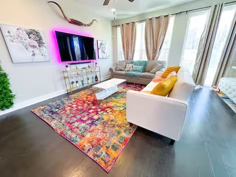 807 E 16th St Unit B, Austin, TX 78702 - living room with a ceiling fan, baseboards, and wood finished floors
