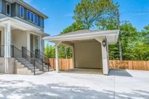 807 E 16th St Unit B, Austin, TX 78702 - view of patio featuring driveway, fence, and a carport