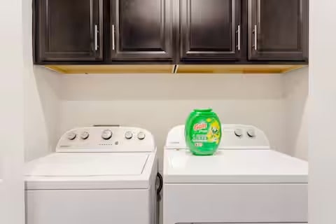 807 E 16th St Unit B, Austin, TX 78702 - laundry room featuring washing machine and dryer and cabinet space