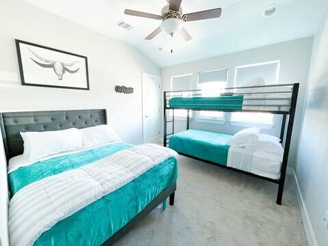 807 E 16th St Unit B, Austin, TX 78702 - carpeted bedroom featuring lofted ceiling, baseboards, and a ceiling fan