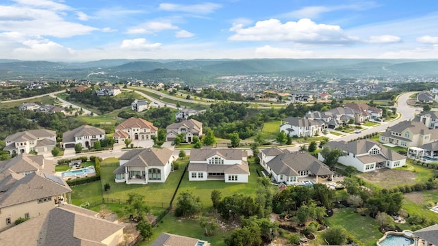 1928 Portobello Rd, Leander, TX 78641 - aerial view of property and surrounding area with nearby suburban area and a mountain backdrop