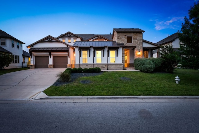 1928 Portobello Rd, Leander, TX 78641 - view of front facade with stone siding, a standing seam roof, concrete driveway, a front yard, and an attached garage