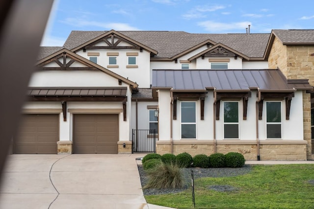 1928 Portobello Rd, Leander, TX 78641 - view of front facade with a standing seam roof, stone siding, concrete driveway, and stucco siding