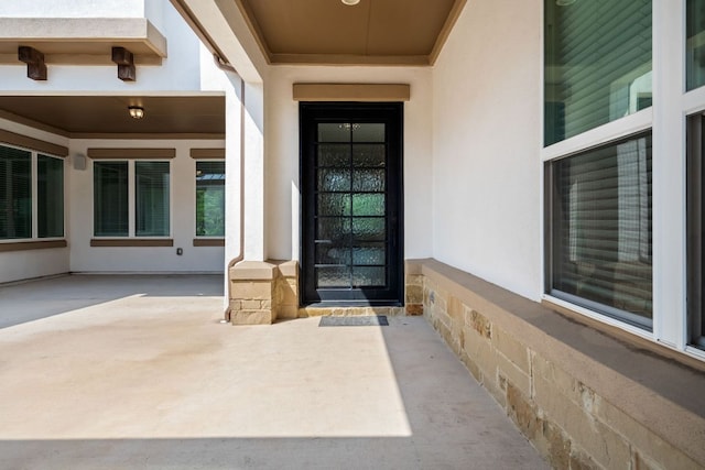1928 Portobello Rd, Leander, TX 78641 - view of exterior entry with stucco siding and a patio