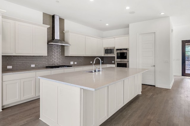 1928 Portobello Rd, Leander, TX 78641 - kitchen with wall chimney exhaust hood, stainless steel appliances, white cabinetry, backsplash, and recessed lighting
