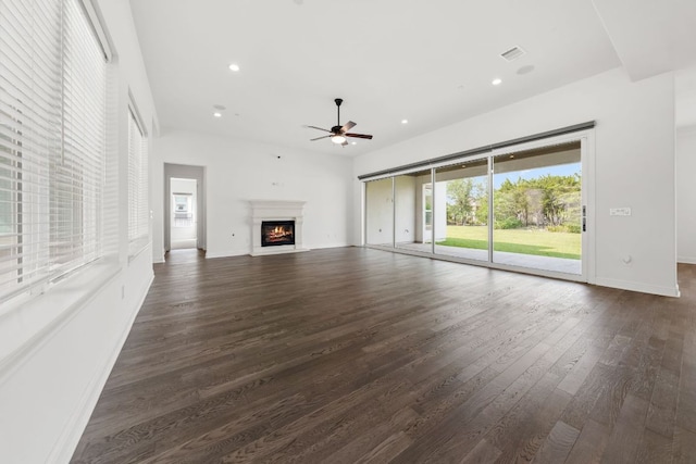 1928 Portobello Rd, Leander, TX 78641 - unfurnished living room featuring ceiling fan, dark wood-style flooring, recessed lighting, and a lit fireplace
