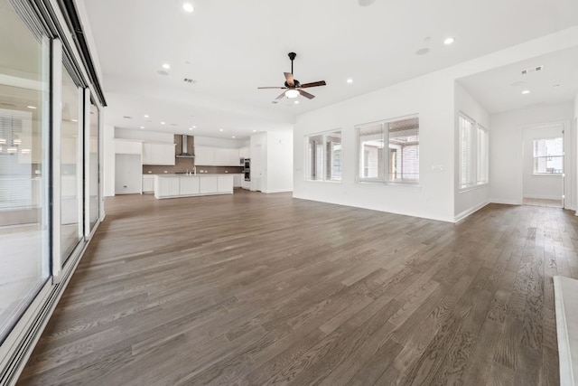 1928 Portobello Rd, Leander, TX 78641 - unfurnished living room featuring a ceiling fan, dark wood finished floors, and recessed lighting
