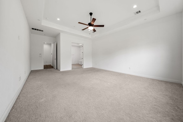 1928 Portobello Rd, Leander, TX 78641 - unfurnished bedroom with a raised ceiling, light colored carpet, recessed lighting, connected bathroom, and a ceiling fan