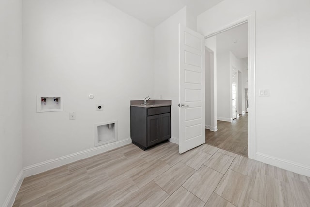 1928 Portobello Rd, Leander, TX 78641 - washroom with electric dryer hookup, cabinet space, light wood finished floors, and hookup for a washing machine