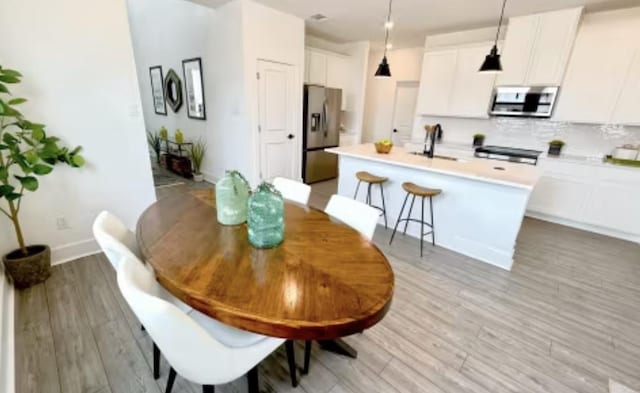 2593 Jack Nora Way, Round Rock, TX 78665 - dining room featuring light wood-style flooring and baseboards