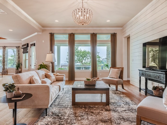 240 Townes Ct, Dripping Springs, TX 78620 - living room with ornamental molding, wood finished floors, a chandelier, wooden walls, and recessed lighting