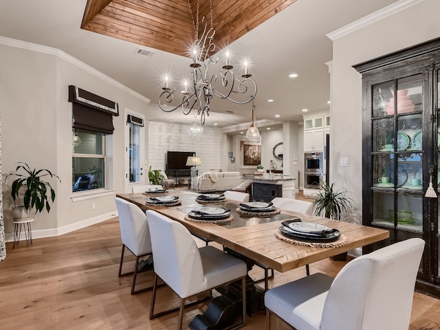 240 Townes Ct, Dripping Springs, TX 78620 - dining area with a chandelier, recessed lighting, light wood-style flooring, baseboards, and ornamental molding