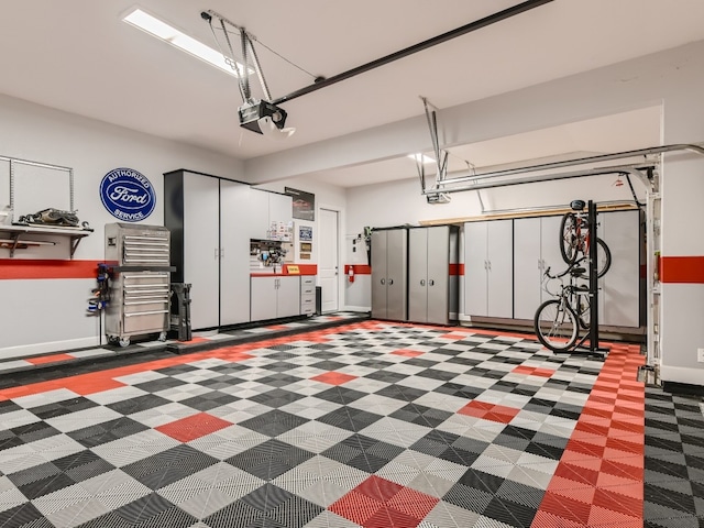 240 Townes Ct, Dripping Springs, TX 78620 - garage featuring a garage door opener and baseboards