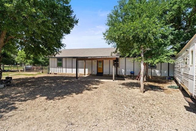 160 Chama Dr, Cedar Creek, TX 78612 - rear view of house with board and batten siding, fence, and driveway