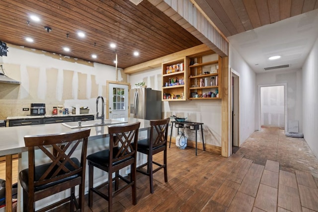 160 Chama Dr, Cedar Creek, TX 78612 - kitchen with stainless steel refrigerator with ice dispenser, wooden ceiling, a sink, dark wood finished floors, and light countertops